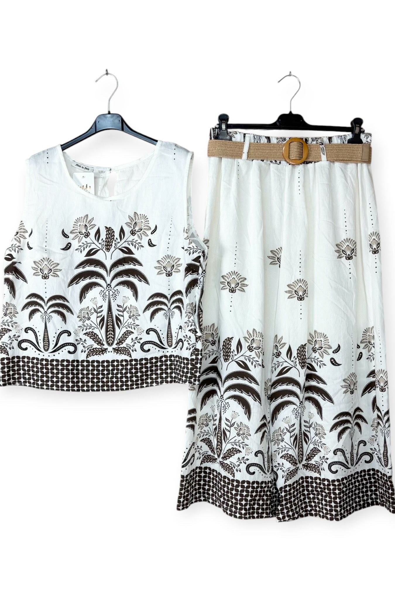 White outfit with brown floral patterns on a white background