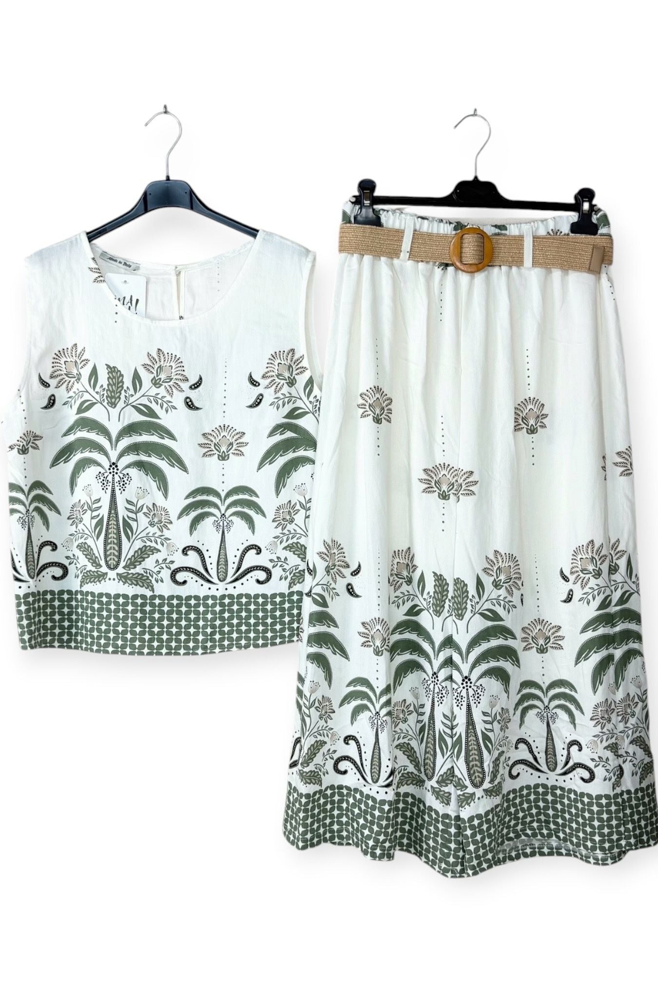 White sleeveless top and trousers with khaki floral patterns on hangers against a white background