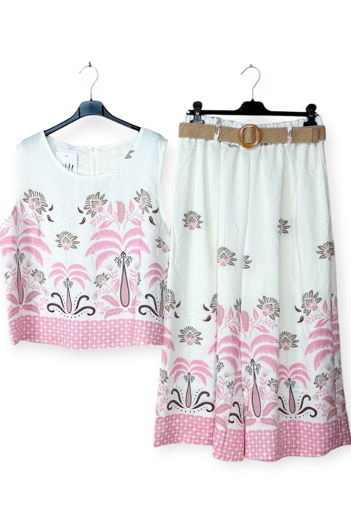 White outfit with pink floral patterns on a white background