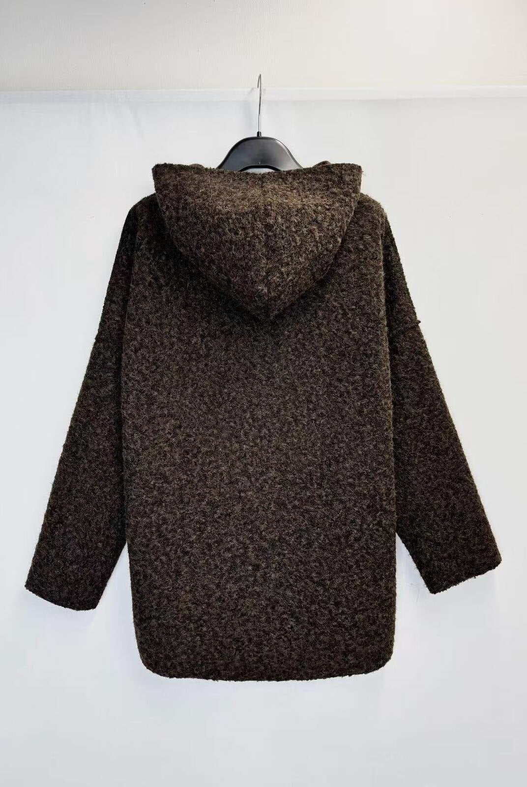 A dark brown textured knit hooded sweater hanging on a black hanger against a plain white background.