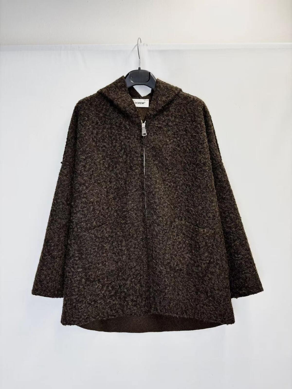 A dark brown textured zip-up jacket with a hood, hanging on a black hanger against a plain white background.