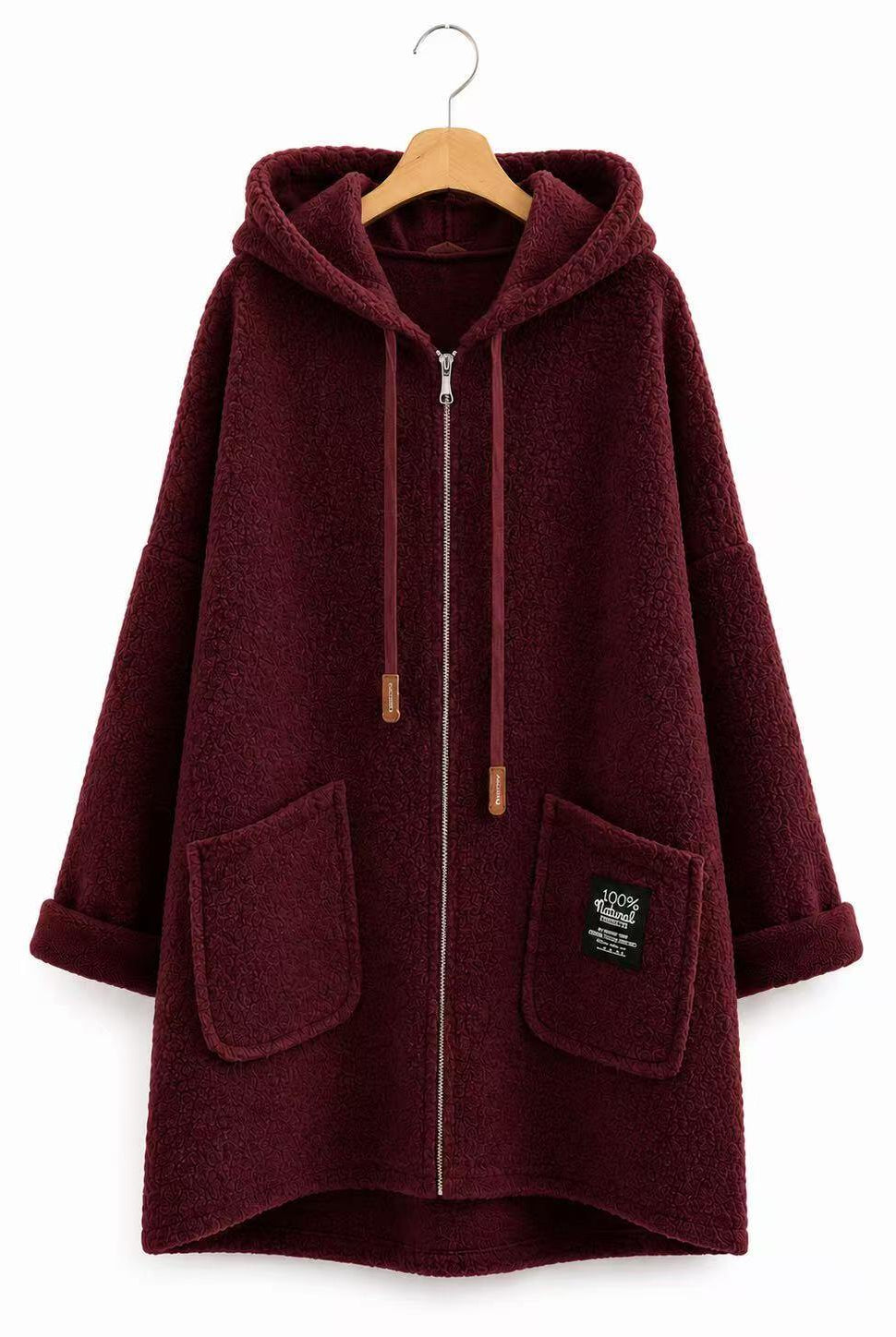 A burgundy sherpa fleece zip-up hoodie with a hood, drawstrings, and front pockets, hanging on a wooden hanger against a white background.