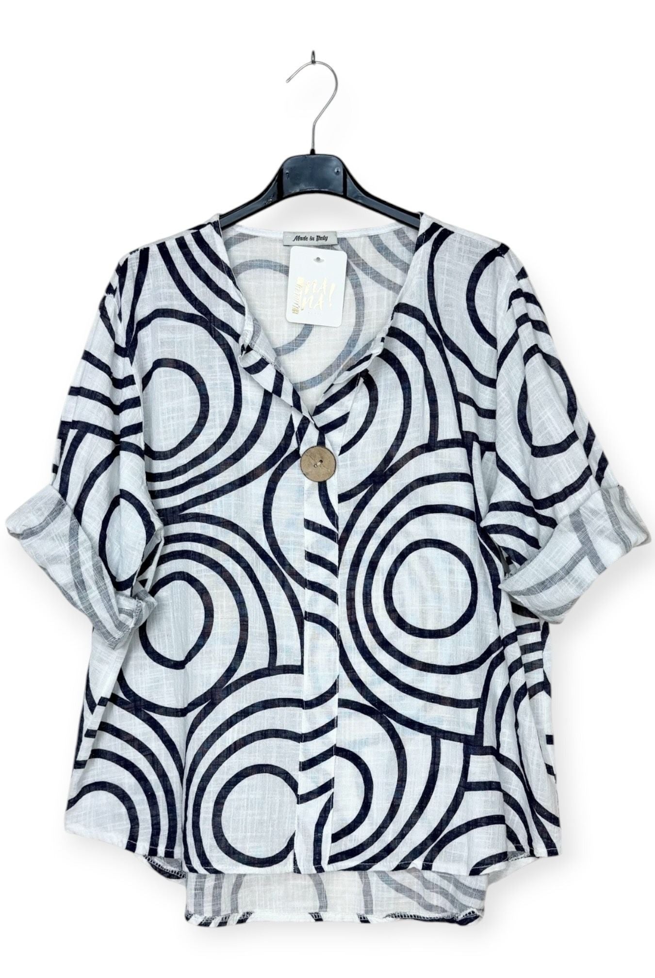 Black and white patterned shirt on a hanger with a white background