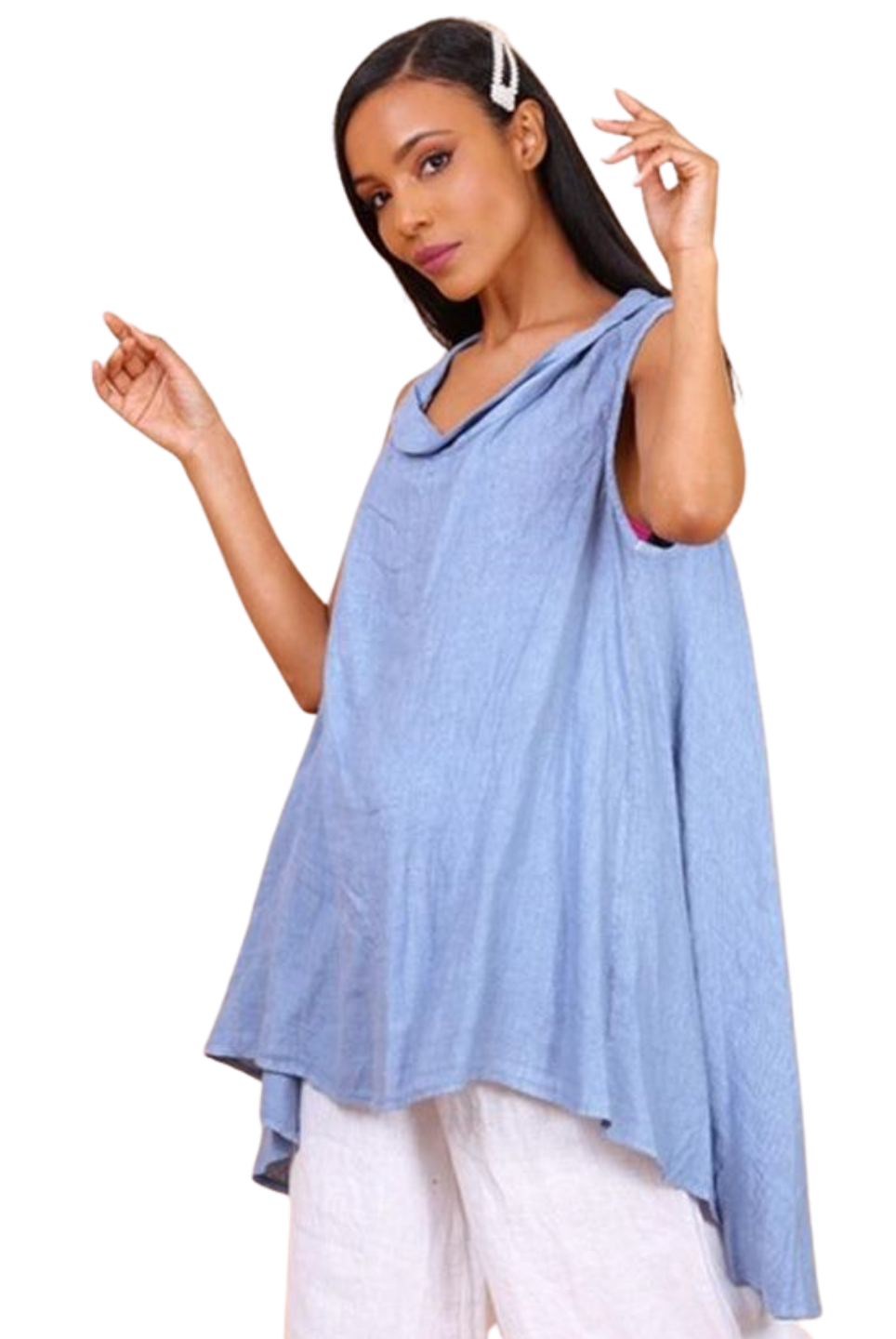 A woman wearing a sky blue sleeveless cowl neck top with an asymmetrical hem, paired with white trousers.