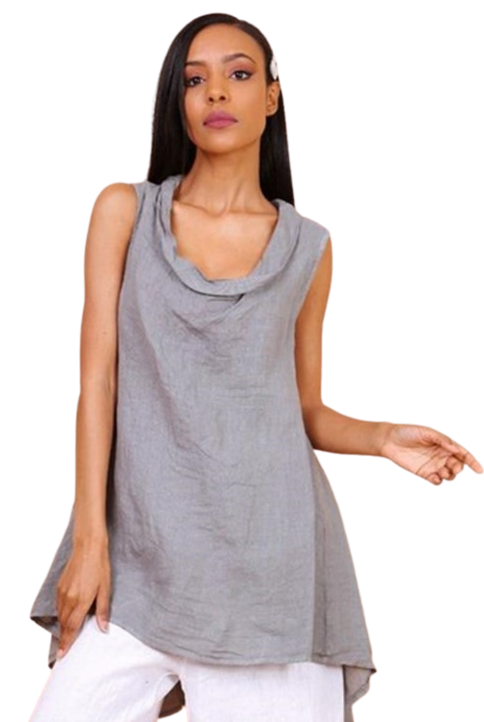A woman wearing a taupe sleeveless cowl neck top with an asymmetrical hem, paired with white trousers.