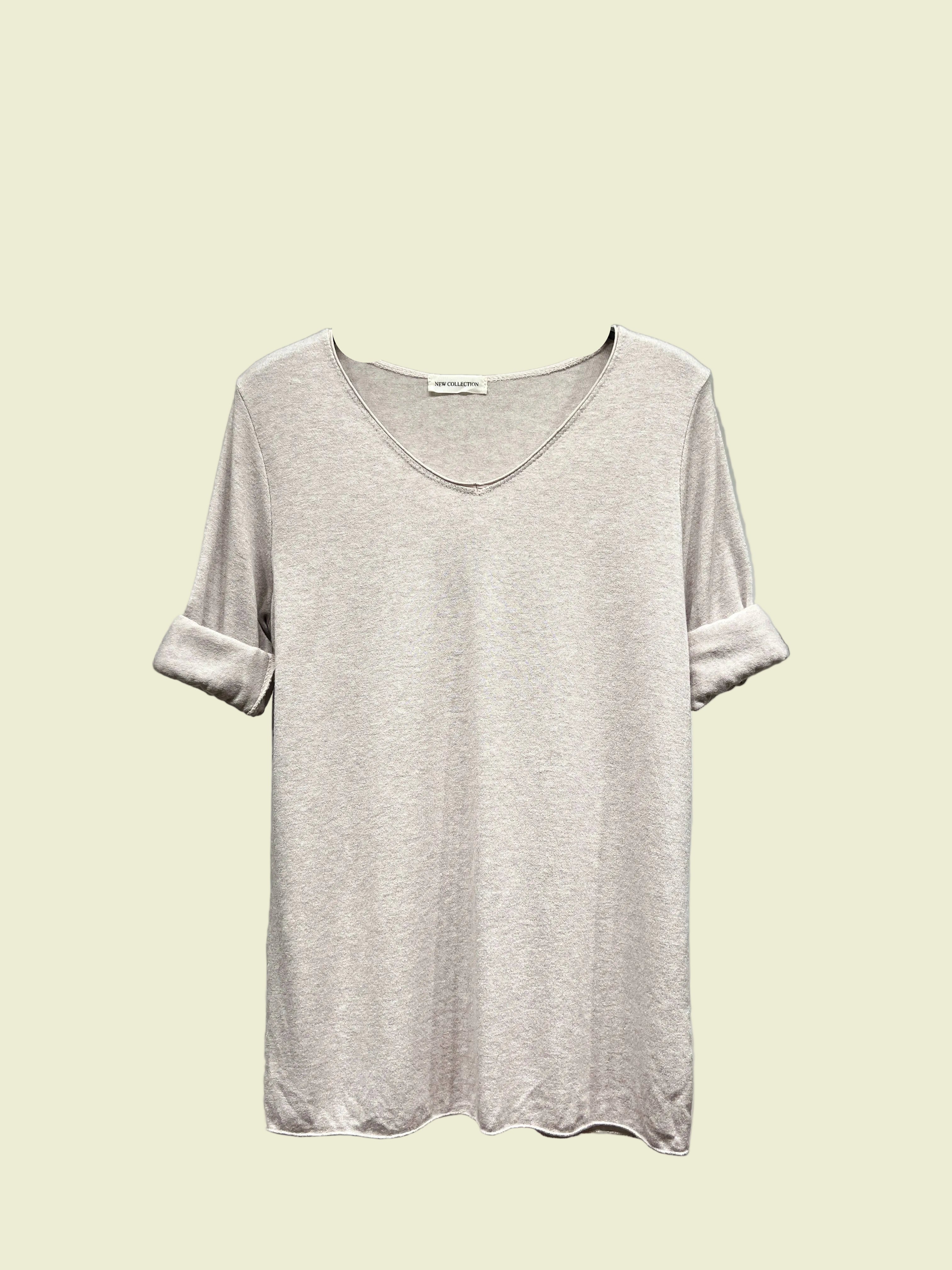 Light Grey t-shirt on a hanger against a neutral background