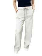 Beige pants worn by a person on a white background
