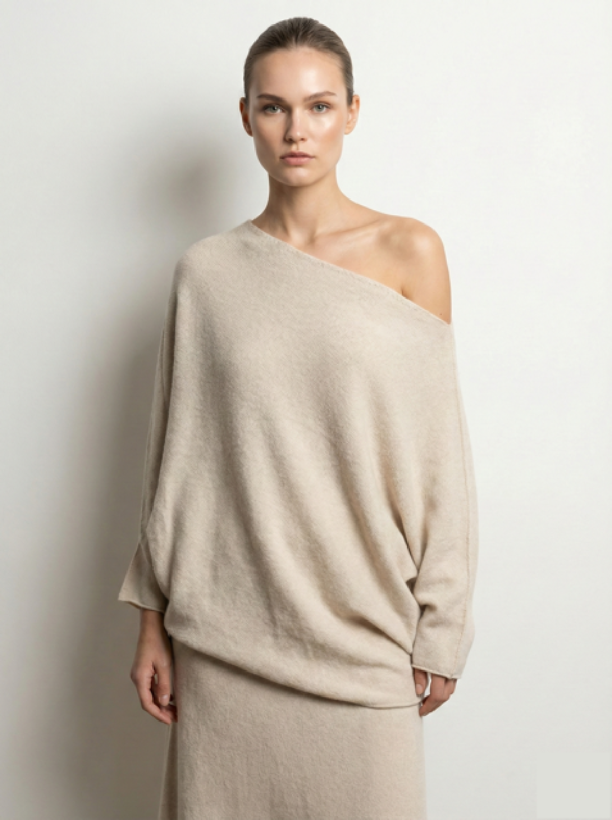 Woman wearing a beige asymmetric sweater