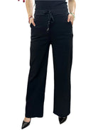 Black wide-leg pants worn by a person on a white background