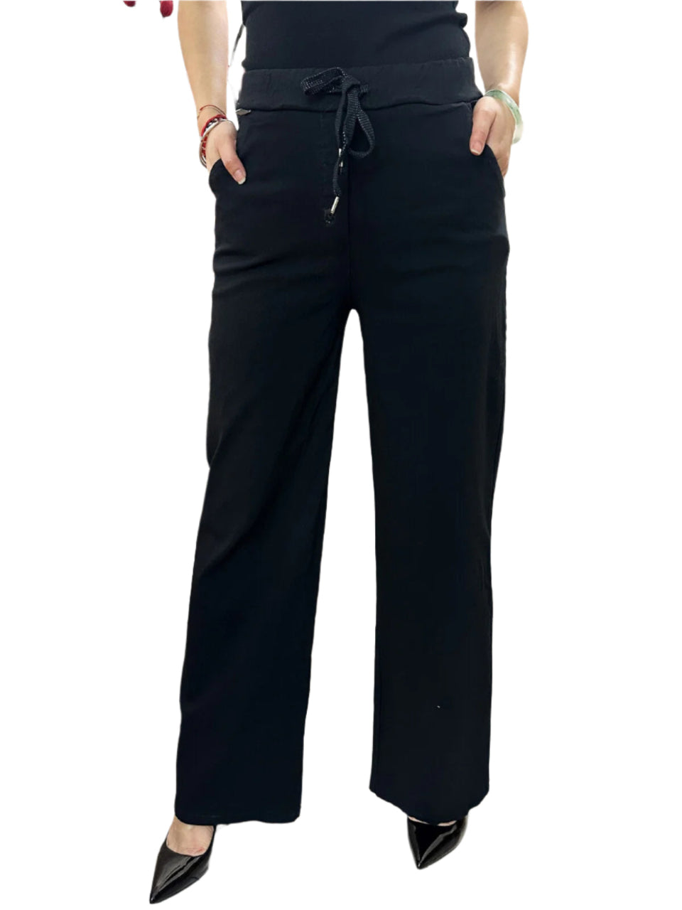 Black wide-leg pants worn by a person on a white background
