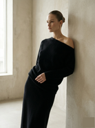 Woman in a black asymmetric sweater
