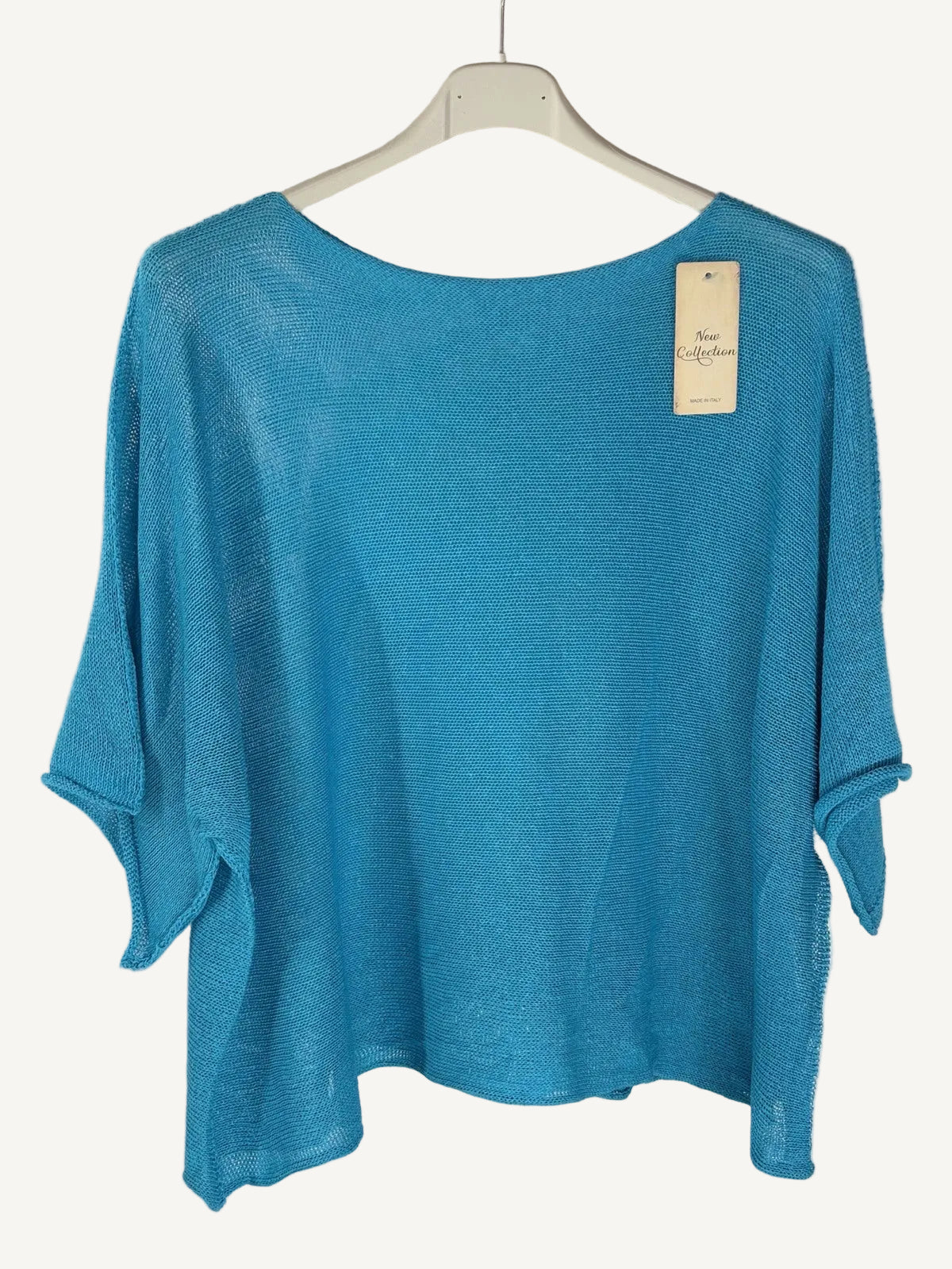 Blue sweater on a hanger with a white background