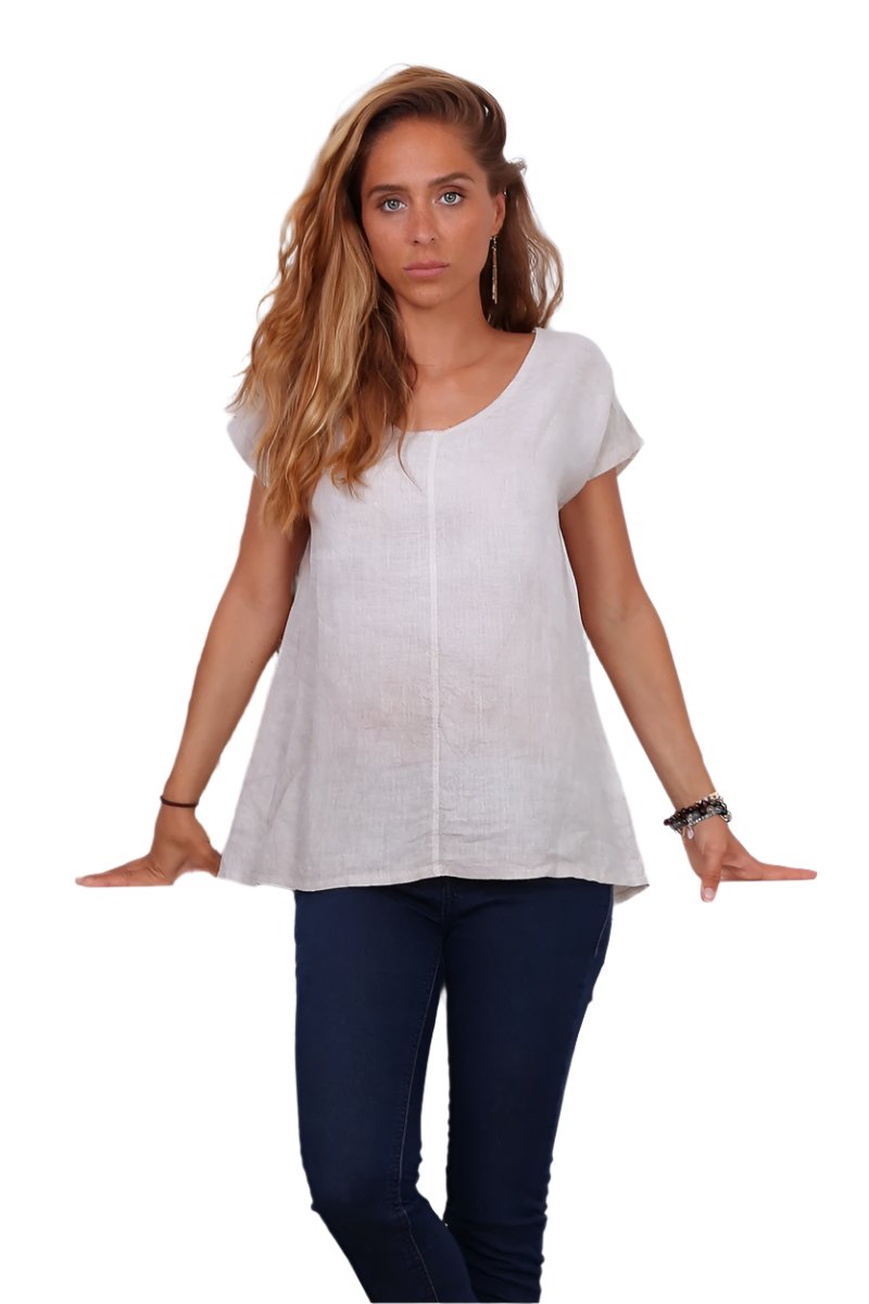 A person wearing a cream v-neck cap sleeve top with a loose fit.