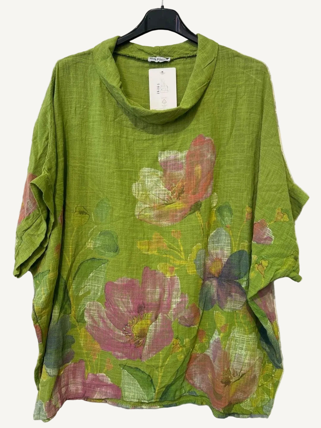 Green floral print top on a hanger against a white background