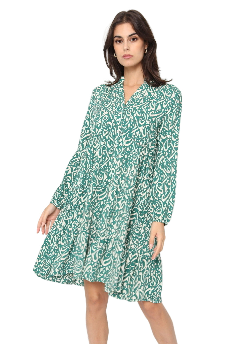 Woman wearing a green patterned dress on a white background