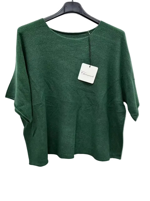 Green sweater on a hanger with a tag against a white background