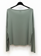 Green long-sleeve top on a hanger against a white background