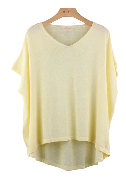 Light yellow sweater on a wooden hanger 