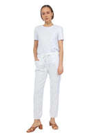 Woman wearing a white t-shirt and pants on a white background