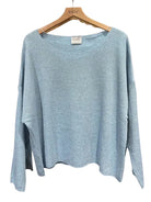 Light blue sweater on a hanger with 'nais' label against a white background
