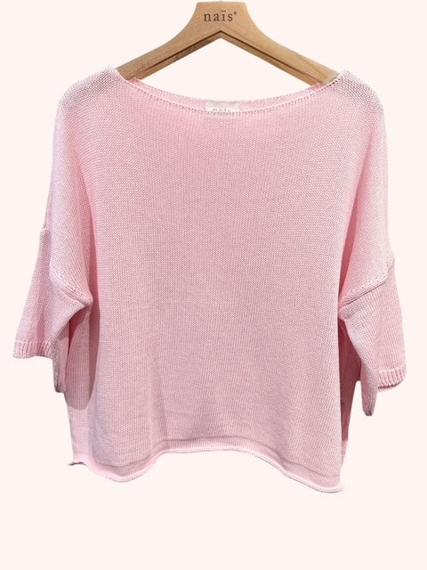 Pink sweater on a hanger with 'nais' label against a white background