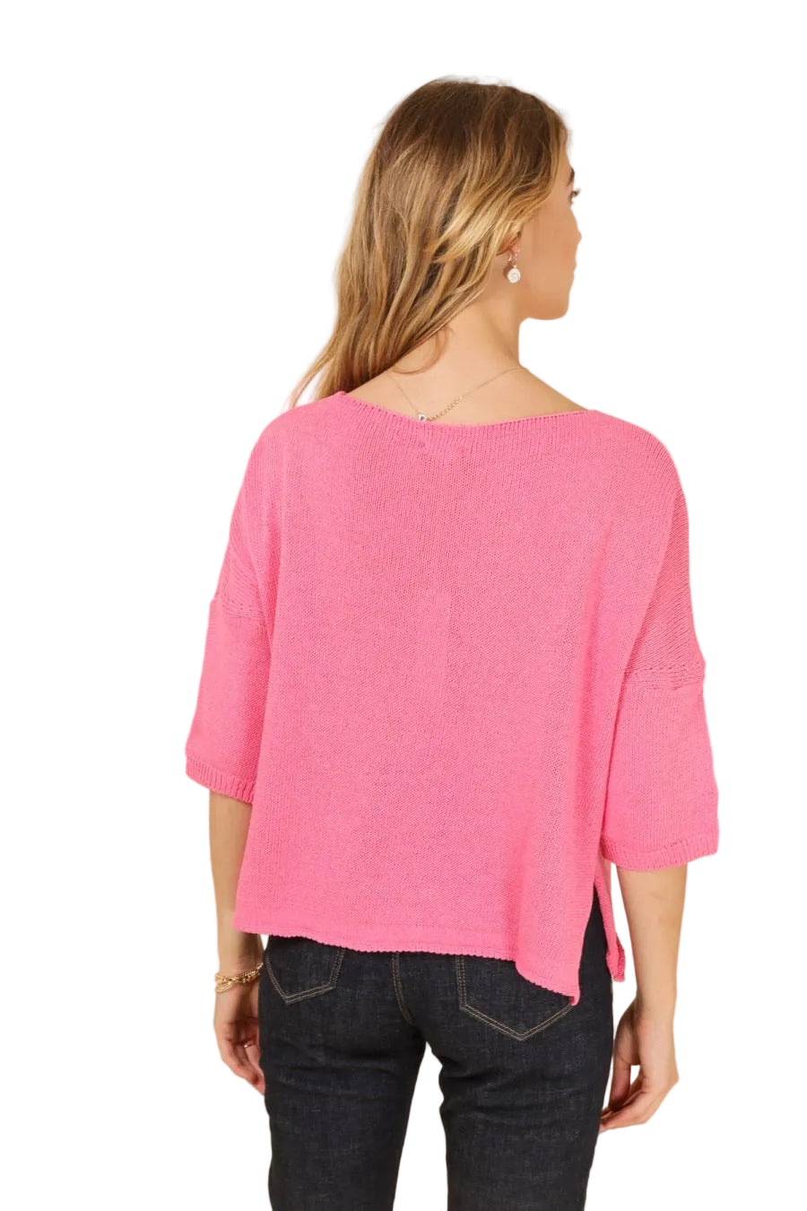Woman wearing a pink sweater with a beige background