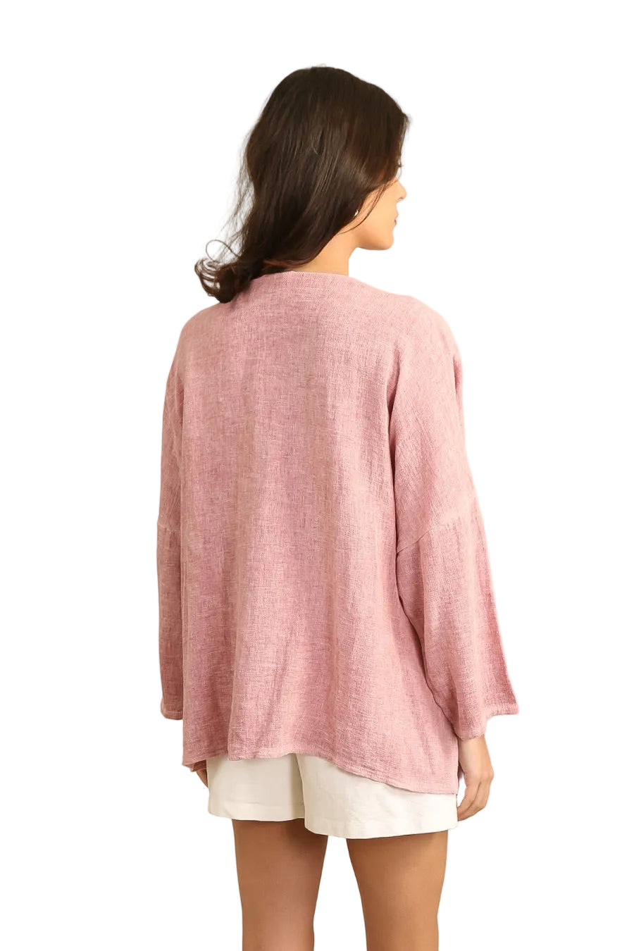 Woman wearing a pink linen tunic on a white background