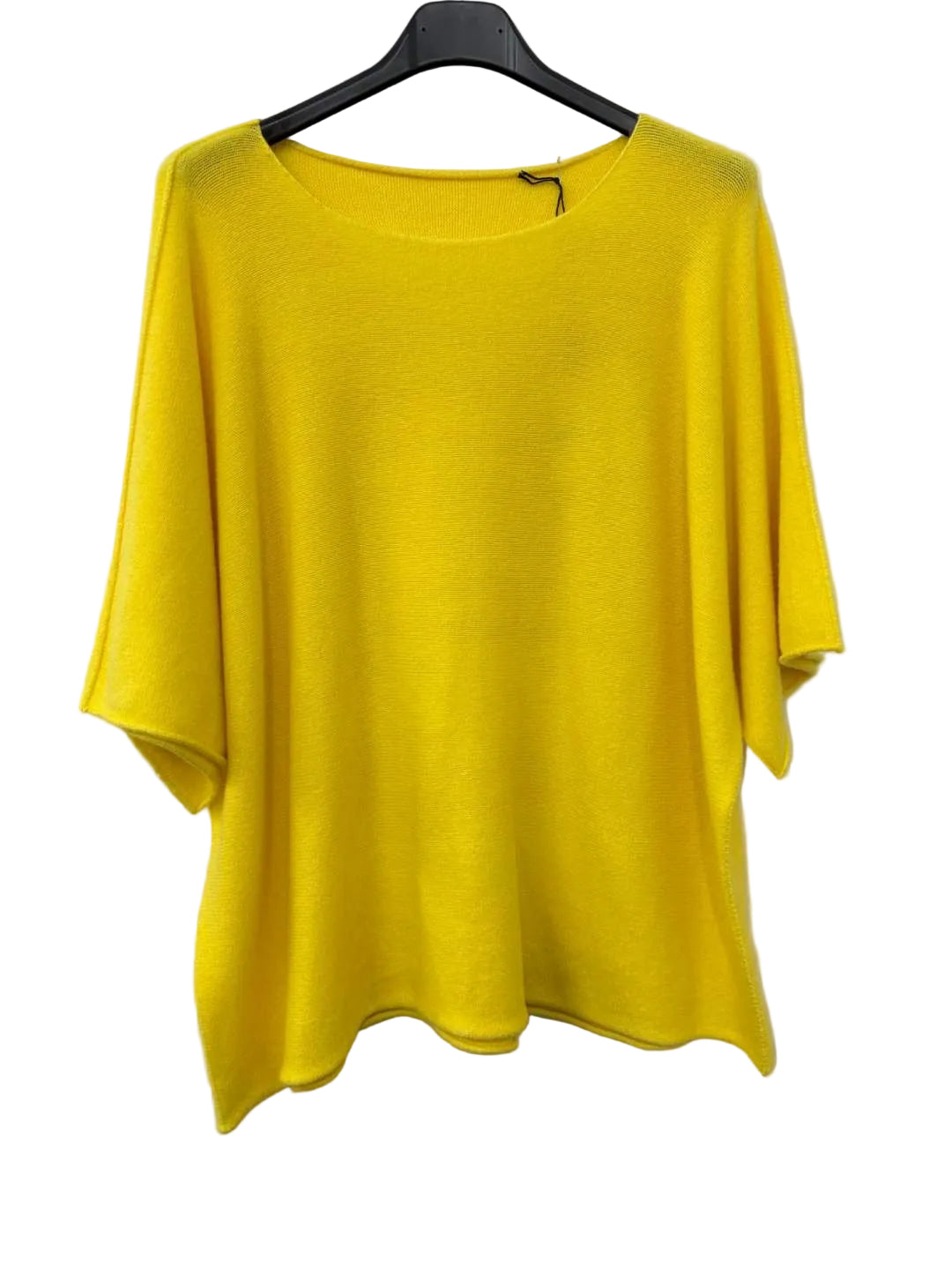 Yellow top on a hanger against a white background