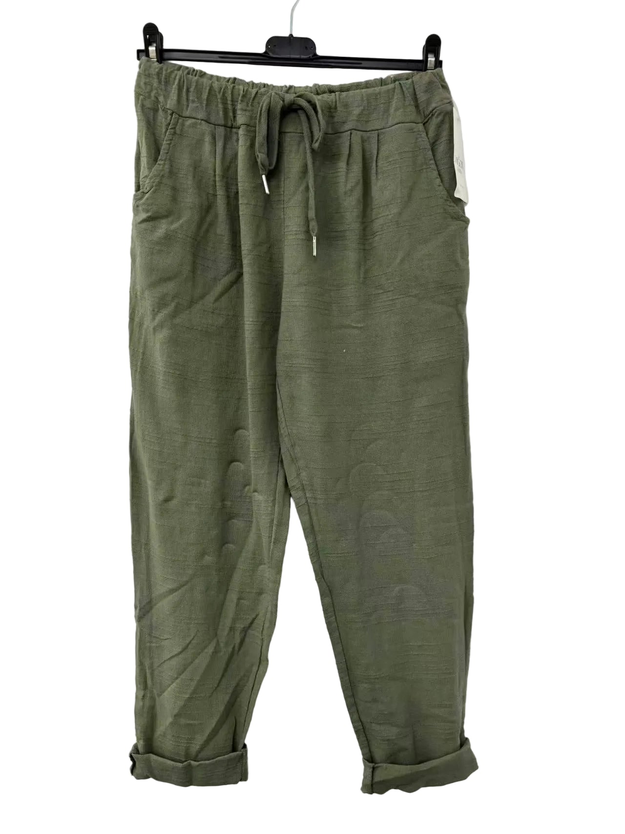 Green pants hanging on a white background