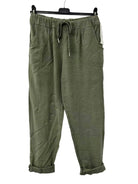 Green pants hanging on a white background