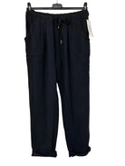 Black pants on a hanger against a white background