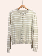 Striped cardigan in beige on a hanger with a light background