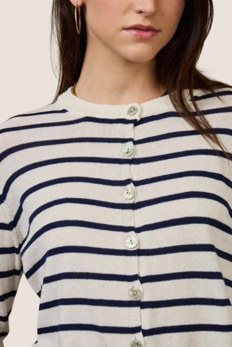 Close-up of a person wearing a striped sweater with visible buttons.
