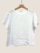 White linen t-shirt on a wooden hanger 