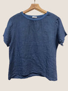Blue t-shirt on a wooden hanger 