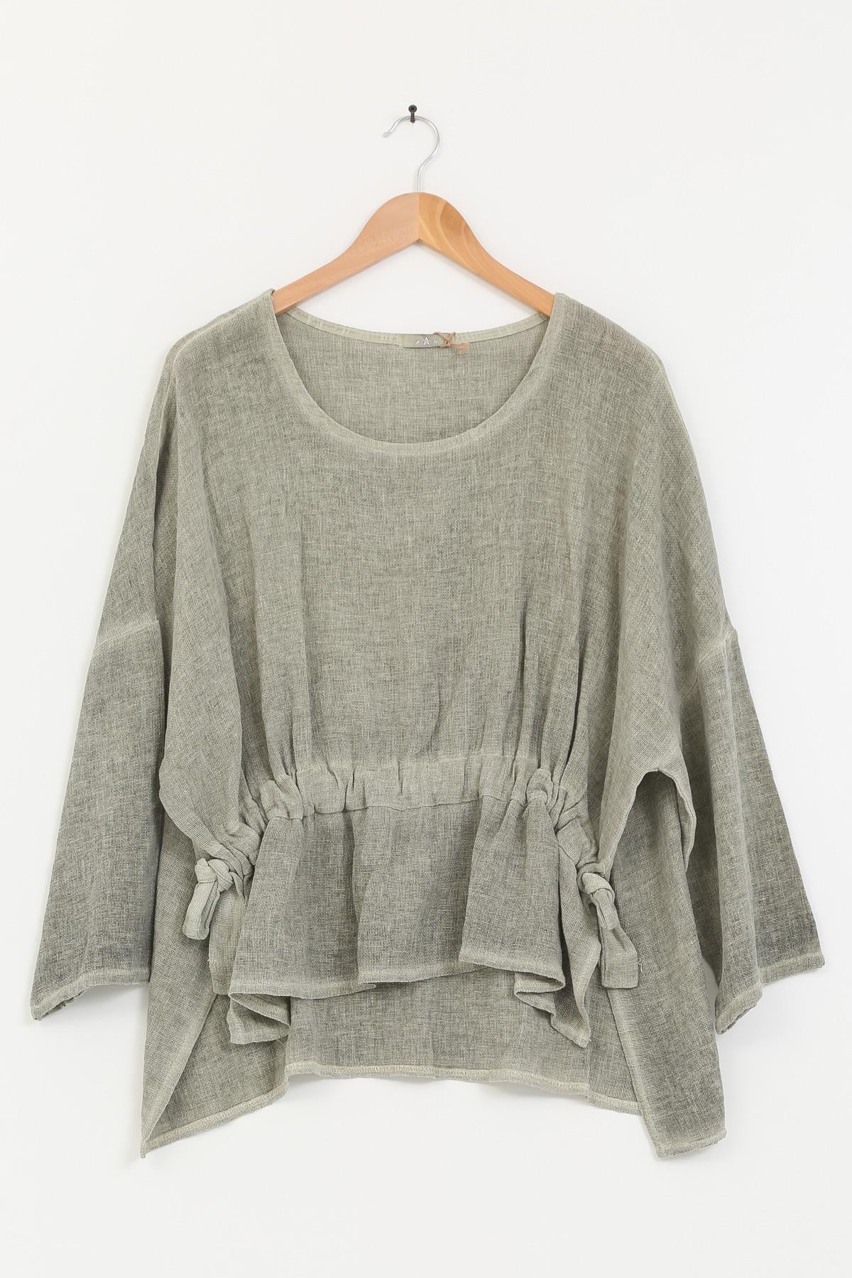 Khaki linen tunic with tie details on a wooden hanger against a white background