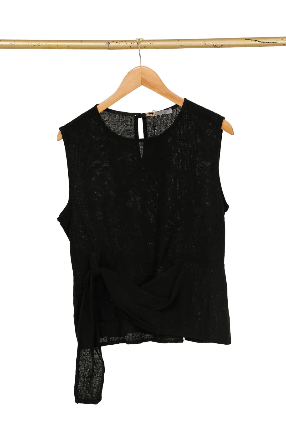 Black sleeveless top on a wooden hanger against a white background