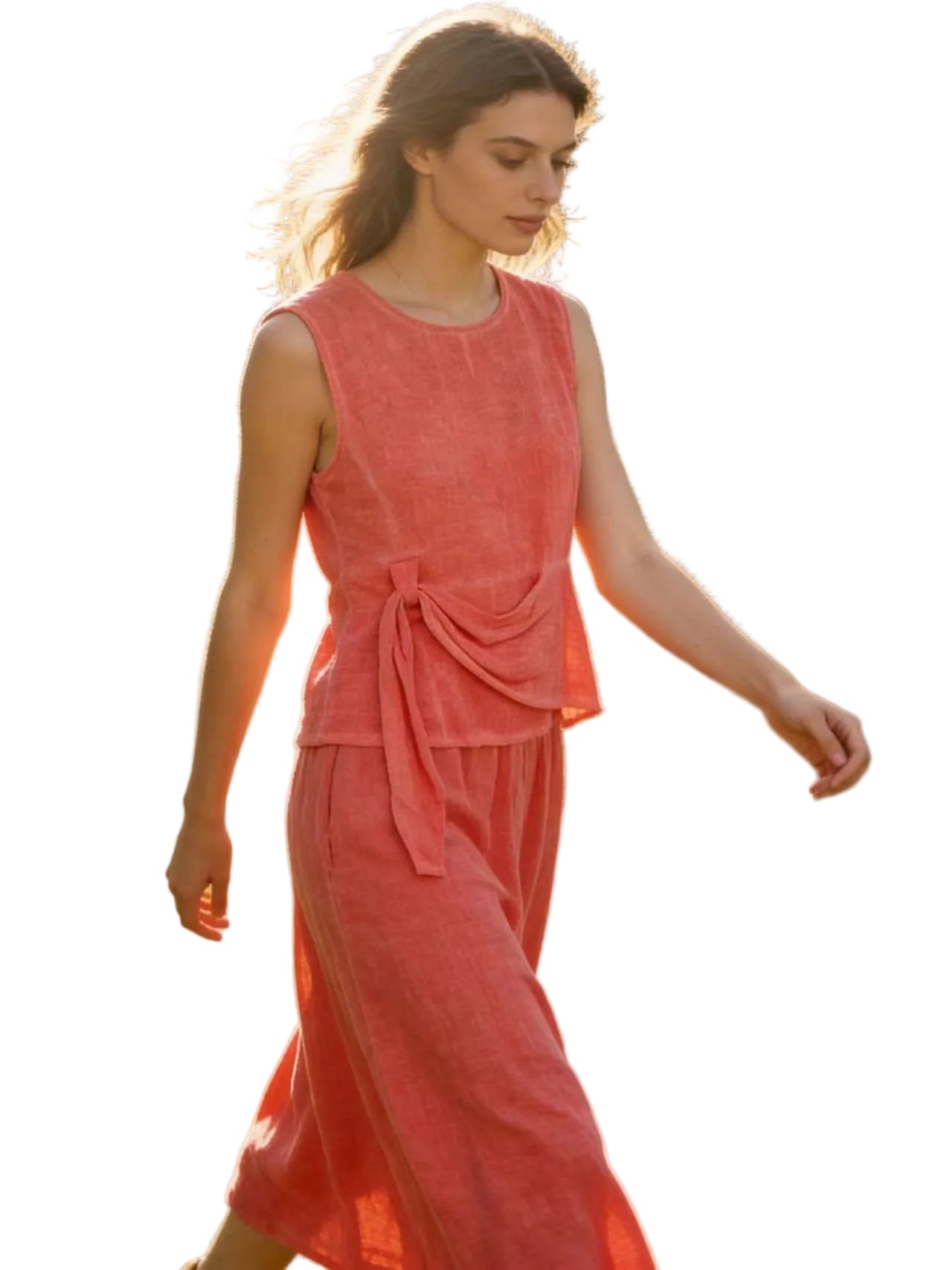 Woman in a coral linen top & skirt with white background