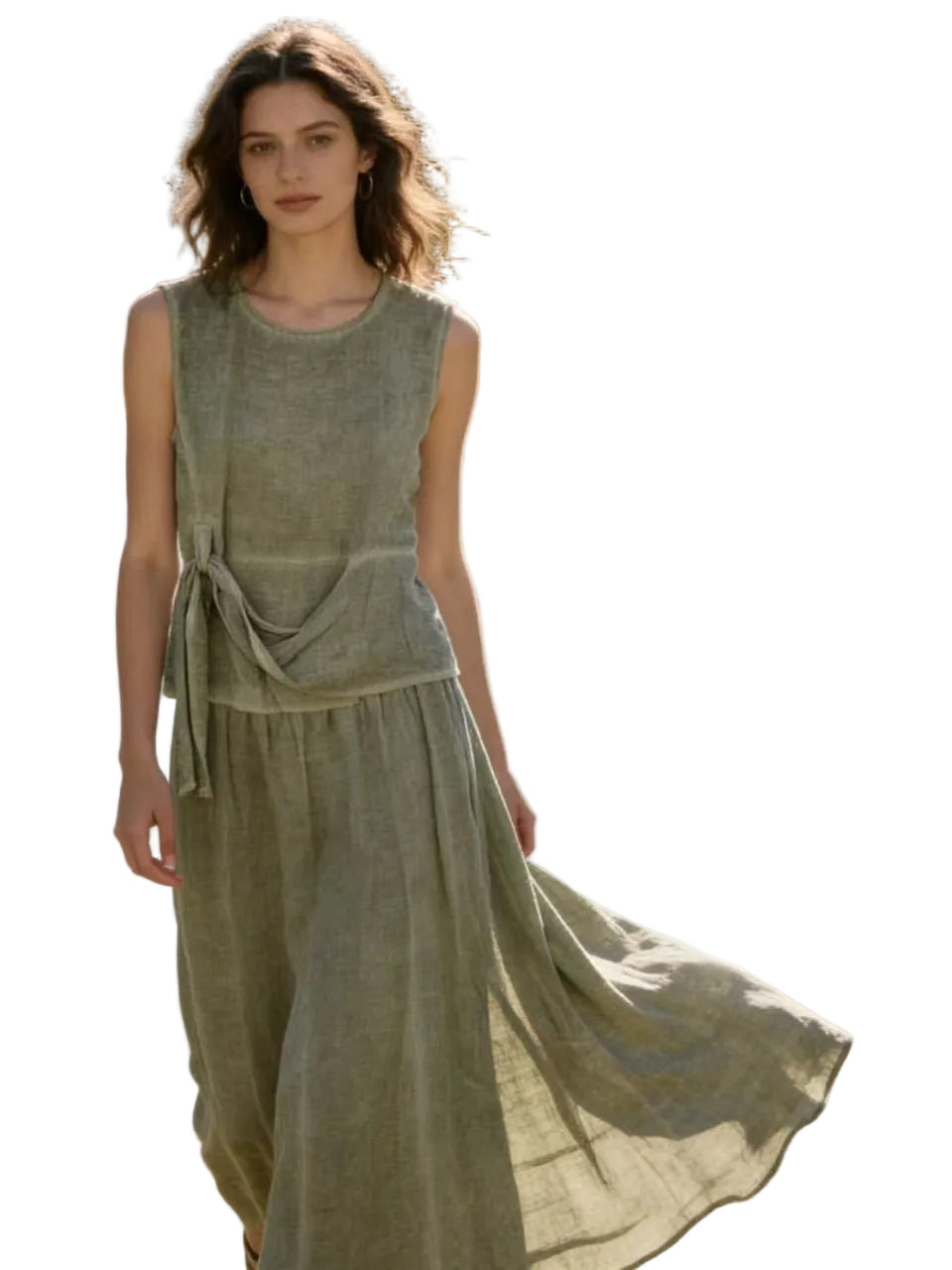 Woman in a flowing khaki top & skirt with a white background