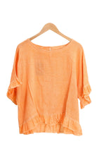 Orange ruffled blouse on a white background