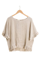 Beige ruffled blouse on a white background