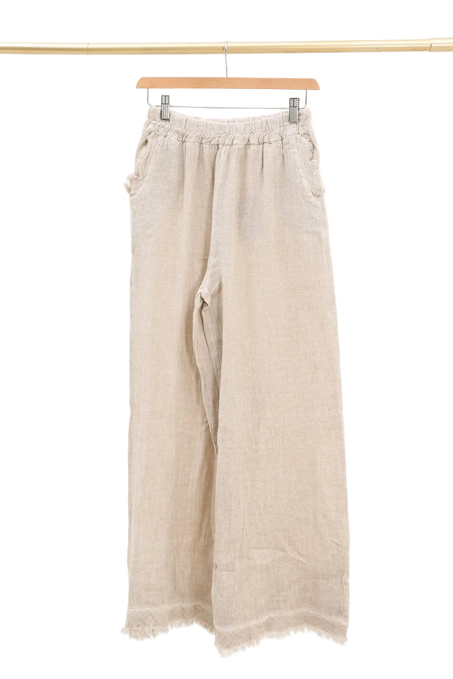 Beige wide-leg pants on a hanger against a white background