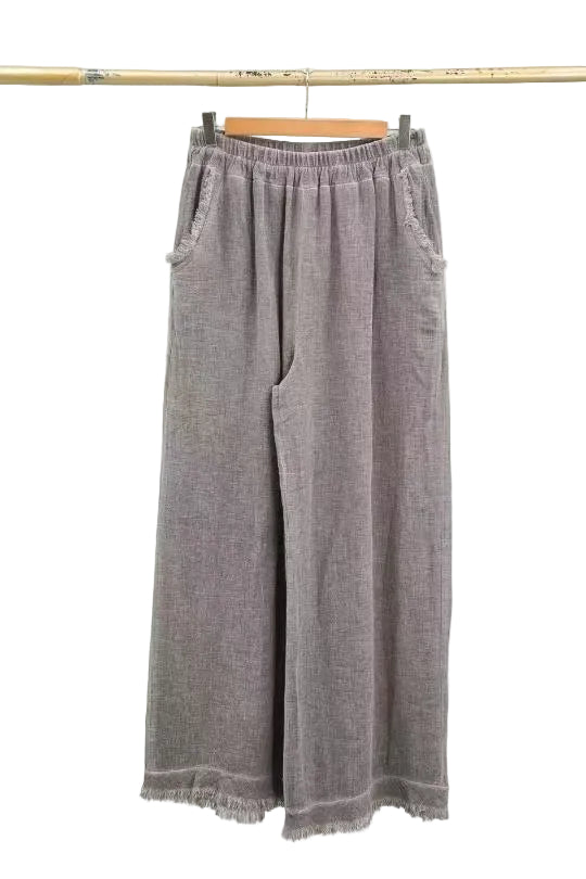 Pair of taupe wide-leg pants on a hanger against a white background