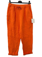 Orange pants with a tag on a white background