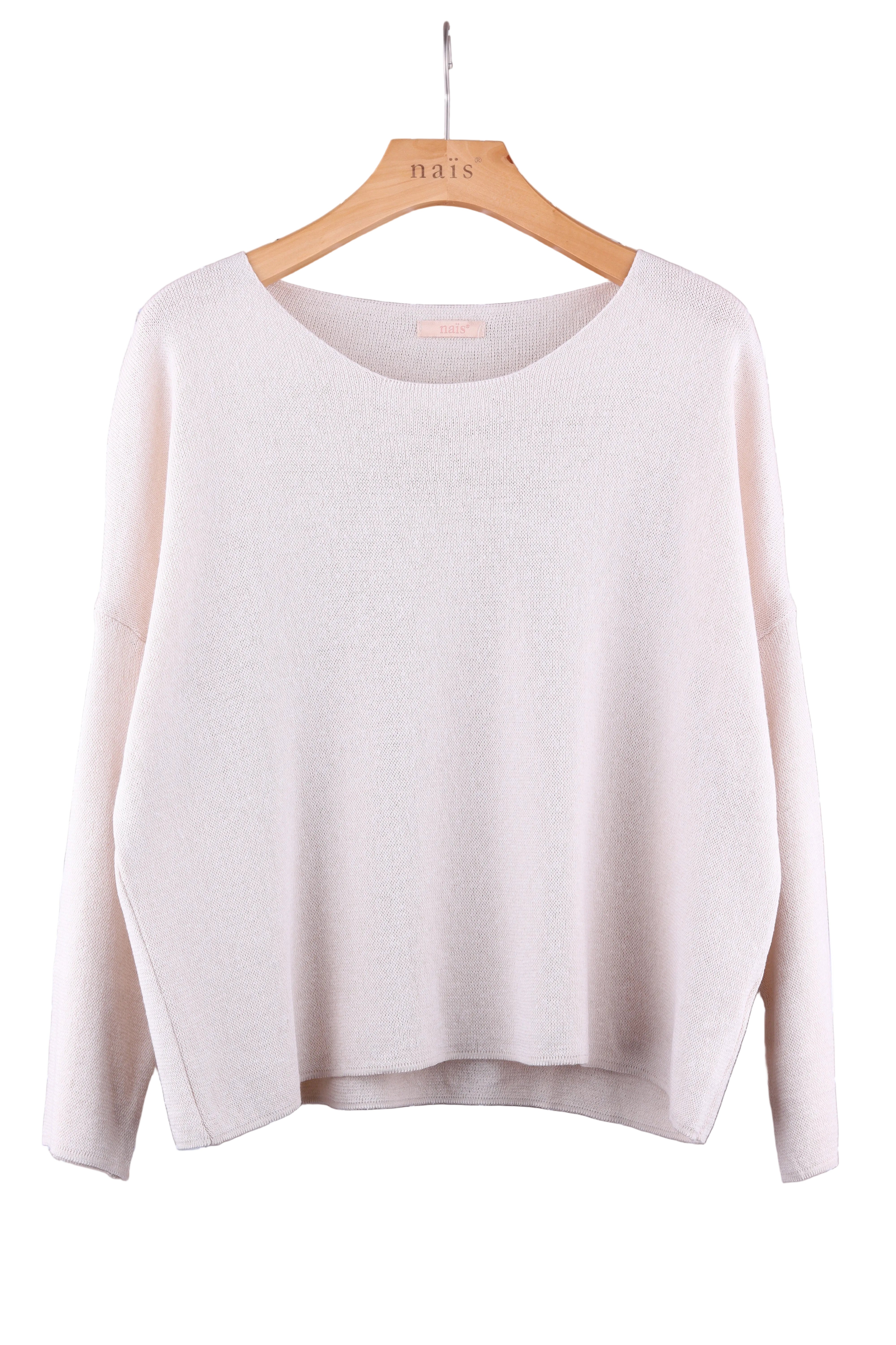 Light beige sweater on a hanger against a white background