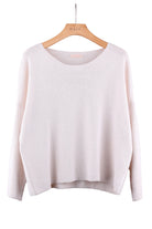 Light beige sweater on a hanger against a white background