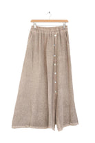 Beige skirt with button details on a hanger against a white background
