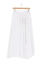 White skirt on a wooden hanger against a white background