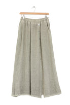 Long khaki skirt with buttons on a wooden hanger against a white background