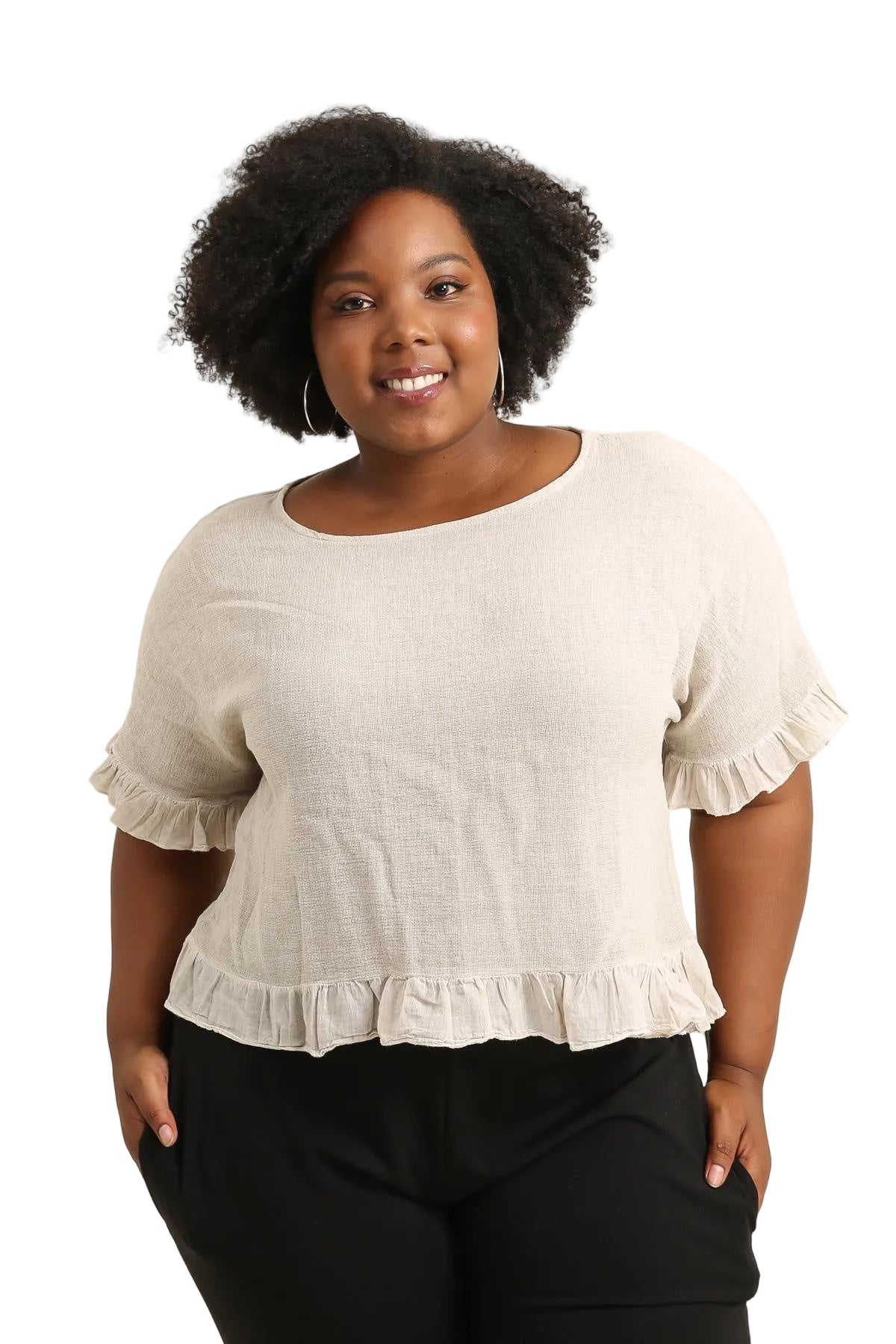 Woman wearing a beige blouse with ruffled sleeves on a white background